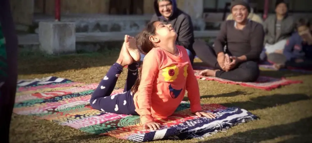 A kid taking meditation session at yoga camp 